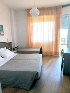 Postel nebo postele na pokoji v ubytování Hotel Turistica + 24 fotografií