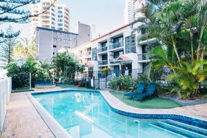 a swimming pool in front of a building at Surfers Paradise- meters from the beach! in Gold Coast