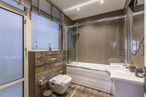 a bathroom with a toilet and a sink and a tub at Comfy Flat near Trendy Attractions in Sisli in Istanbul