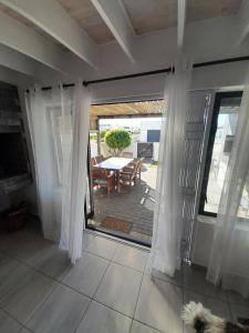 a view of a patio from the inside of a house at @ the reef Holiday Home in St. Helena Bay