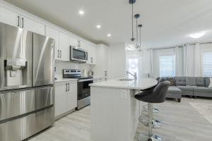 a kitchen with a stainless steel refrigerator and a counter at 3bedroom Stylish Getaway by the Park with 2-Car Garage in Calgary