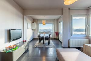 a living room with a table and a tv at Stylish Apartment with Bosphorus View in Besiktas in Istanbul