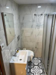 a small bathroom with a sink and a shower at Hotel Otağ in Istanbul