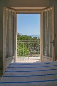 a bedroom with a bed and a view of the ocean at Hotel Annita Cervia in Cervia