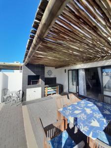 a patio with a table and chairs on a patio at @ the reef Holiday Home in St. Helena Bay