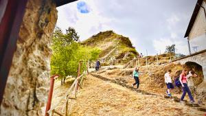 a group of people walking down a dirt road at Laura Guest House Sasso di Castalda in Sasso di Castalda