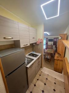 a kitchen with a refrigerator and a stove at Il Covo House in Roccaraso