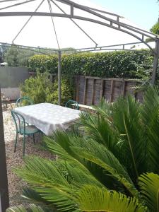 a white table and chairs under an umbrella at Casa Garibaldi in Lucca