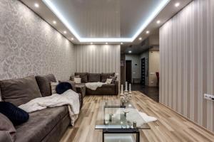 a living room with a couch and a table at Viktoria Garden apartment in Lviv +1 photo