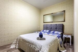 a bedroom with a bed with a mirror on the wall at Viktoria Garden apartment in Lviv