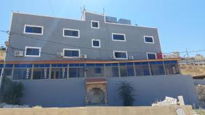 a large building on top of a building at Petra Guests Hotel in Wadi Musa