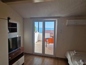 a room with a sliding glass door leading to a patio at Villa Gaj in Novalja