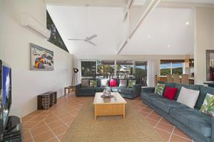 a living room with a couch and a table at 44 Cooran Court in Noosa Heads