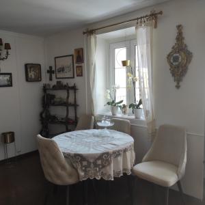 a dining room with a table and chairs and a window at Guesthouse Bogdanovic in Budva