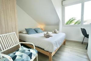 מיטה או מיטות בחדר ב-Duplex des 4 chemins