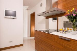 a kitchen with a sink and a stove top oven at OrangeHomes One bedroom apartment with fireplace in Budapest