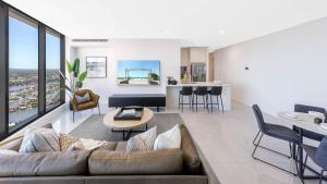 a living room with a couch and a table at Surfers Paradise New Beachfront 2&3 BED APT in Gold Coast