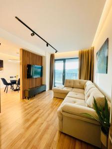 a living room with a couch and a television at 19th floor Apartment in Cluj-Napoca