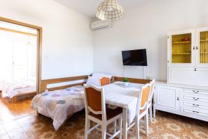 a dining room with a table and a tv at Apartments Lonzor I in Selce