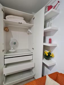 a walk in closet with white shelves at Plaza Mostenses en Plaza España in Madrid