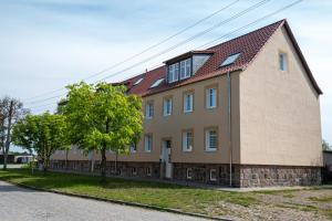 a large brick house with a red roof at VIP Apartment A 64qm 4 Zi DG Wohnung klimatisiert großes Bad u Küche max 4 Gäste inklusive Schlafsofa in Vierraden