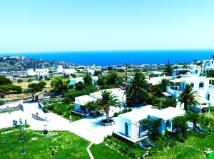 an aerial view of a town with white buildings and the ocean at ANCIENT MEROPIA - Astrogonio, Apollonia in Apollonia