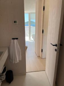 a hallway with a door open to a bathroom at BUQEZ ECO RESORT - Beach Villas 2 and 8 - Seaview, new wifi! in Drage