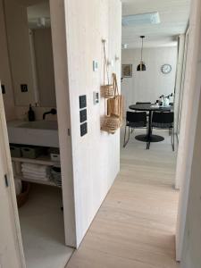a hallway leading to a kitchen with a dining table at BUQEZ ECO RESORT - Beach Villas 2 and 8 - Seaview, new wifi! in Drage
