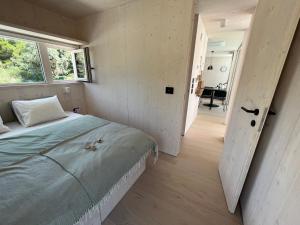 a bedroom with a large bed and a window at BUQEZ ECO RESORT - Beach Villas 2 and 8 - Seaview, new wifi! in Drage
