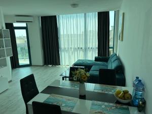 a living room with a couch and a table at Spacious and cozy Apartment in complex Del Sol in Primorsko