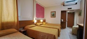 Postel nebo postele na pokoji v ubytování Hotel Delta Florence