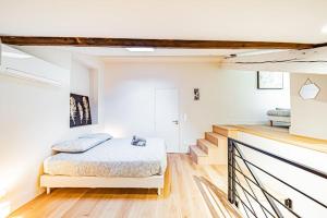 a bedroom with a bed and a staircase at Bellecour Prestige-Coeur de Lyon in Lyon