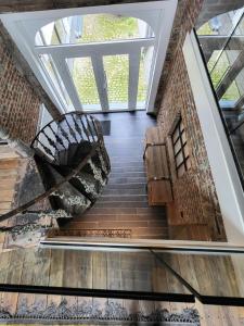 a spiral staircase in a building with a window at Luxury Spa Gîte - Loft Luxe in Spa