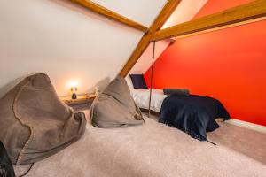 a room with a bed in the corner of a room at Luxury town centre loft apartment in converted Granary in Stamford