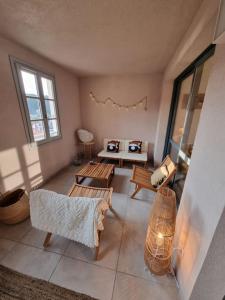 a living room with two tables and a couch at D34 - T3-Les Hauts du Port-parking-clim-wifi-50m du port in Bonifacio