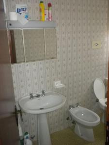 a bathroom with a sink and a toilet at A due passi da Asiago... in Cesuna