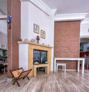 a living room with a fireplace and a table at Abelia Otel in Çanakkale