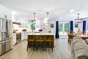 a kitchen and living room with a couch and a table at Christys Cottage with Hot Tub - 2 Mi to Beach! in Snow Hill