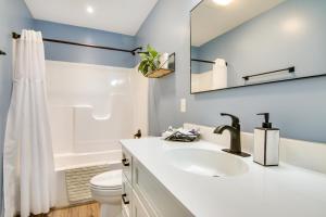 a bathroom with a sink and a toilet and a mirror at Christys Cottage with Hot Tub - 2 Mi to Beach! in Snow Hill +33 photos