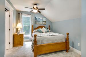 a bedroom with a bed and a ceiling fan at Christys Cottage with Hot Tub - 2 Mi to Beach! in Snow Hill