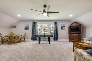 a living room with a ceiling fan and a table at Christys Cottage with Hot Tub - 2 Mi to Beach! in Snow Hill