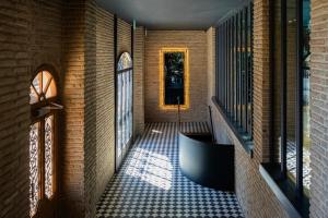 a hallway of a house with a tile floor at Puris Moedani Boutique Hotel in Tbilisi City