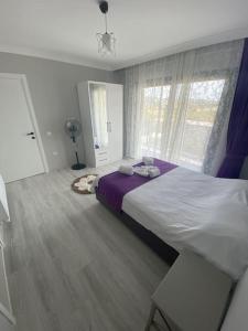 a bedroom with a large bed and a window at Villa Keyif in Seferihisar +36 photos