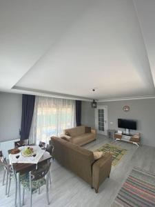 a living room with a couch and a table at Villa Keyif in Seferihisar