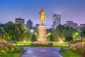 a statue in a park with a city in the background at The Boston Rental - Multiple Floorplans in Boston