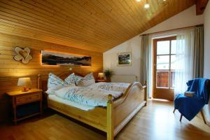 a bedroom with a large bed with a wooden ceiling at Ferienwohnung Amann in Vandans