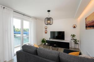 a living room with a couch and a tv at Apartman Vista Metković in Metković
