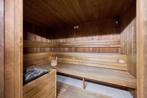 a sauna with wooden walls and a wooden ceiling at Walońska 16 Sauna & Fitness Family Apartments by Renters Prestige in Wrocław
