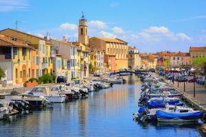 a group of boats docked in a canal with buildings at MARTIGUES Adorable petite guest house in Martigues