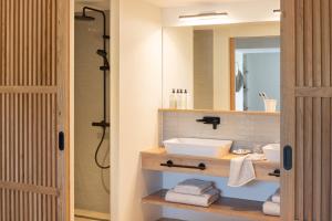 a bathroom with a sink and a mirror at Hôtel L'Escalet in Ramatuelle